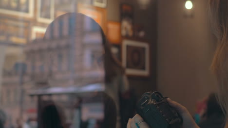 woman with camera taking shots of a man in cafe