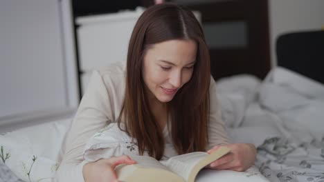 woman reading a book in bed