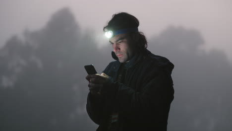 man, forest and phone in night