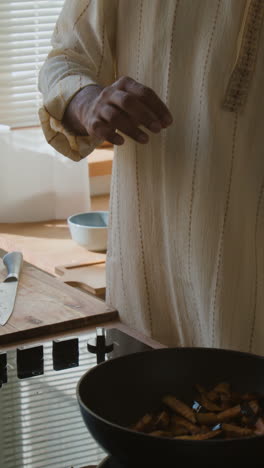 person cooking food in a kitchen