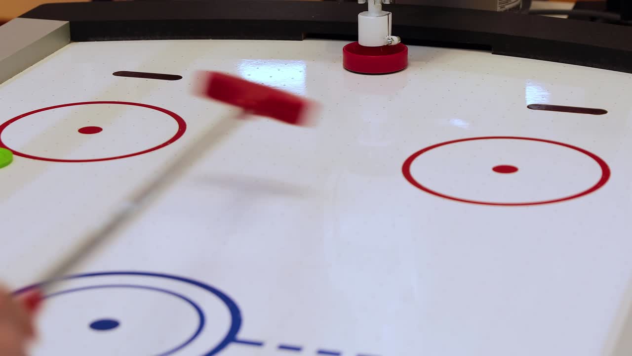 el robot juega hockey aéreo con un hombre. campo de juego para mini hockey.