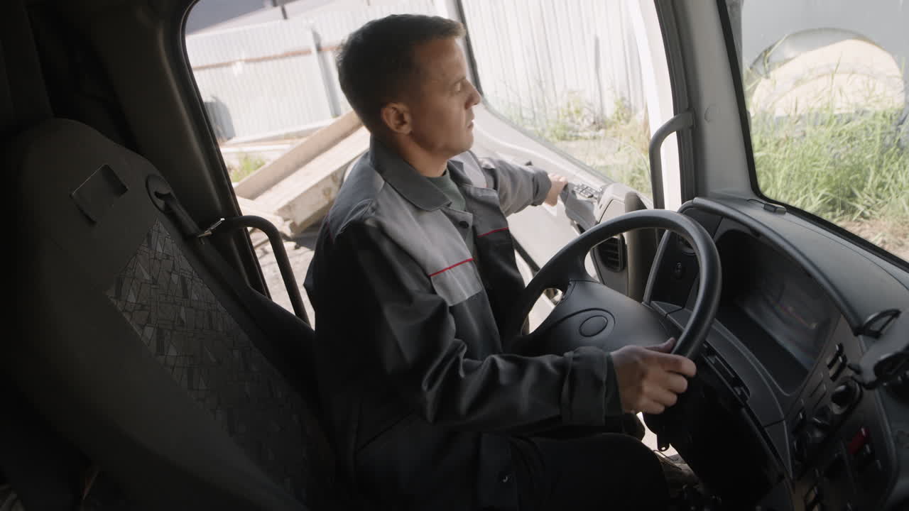 Truck driver in the cab of a truck