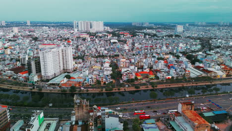 aerial view of residential houses near a river in ho chi city. the shot captures cozy neighborhoods, winding streets, and lush greenery alongside the river, highlighting urban and natural harmony