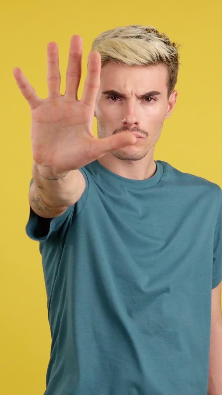 Man holding hand up in stop gesture