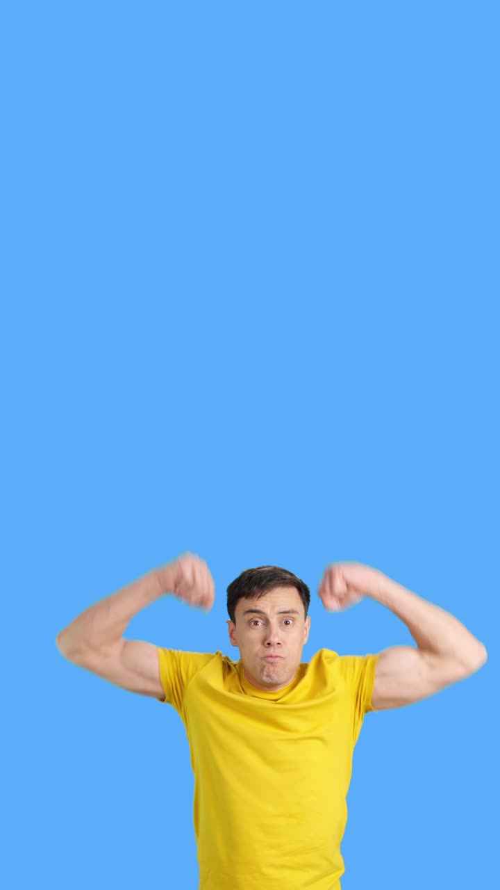 Man making funny faces in front of a blue background