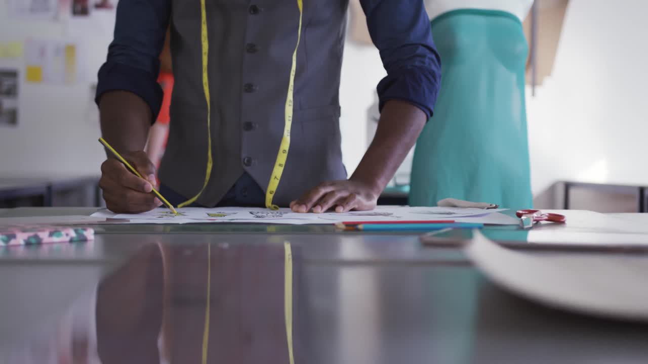 Mixed race man working in fashion office