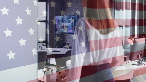 american flag animation over businesswoman working at desk in modern office