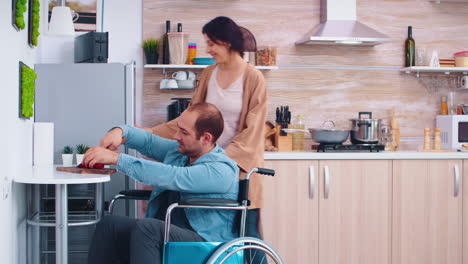 Disabled-man-in-wheelchair-chopping-bell-pepper-in-kitchen