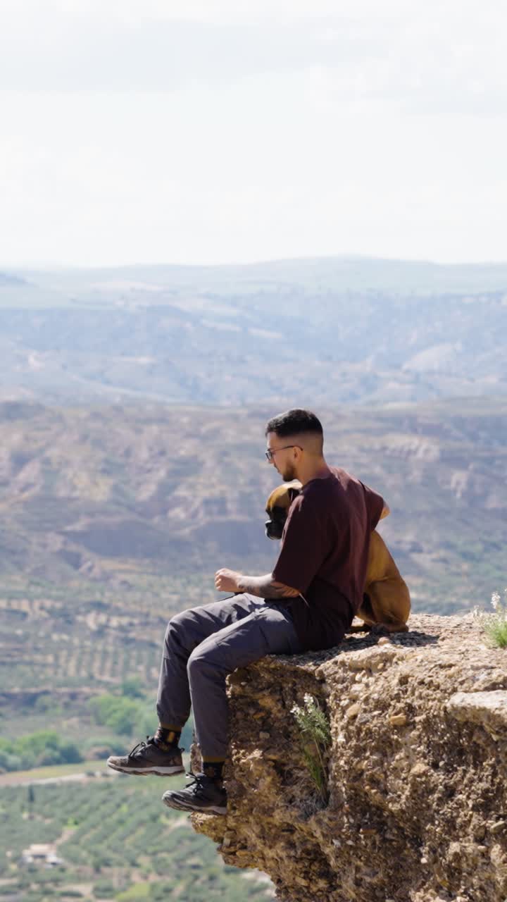 Tourist enjoying the view from a cliff in gorafe, spain. Vertical