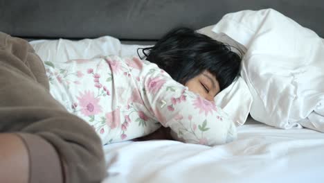 child sleeping in bed