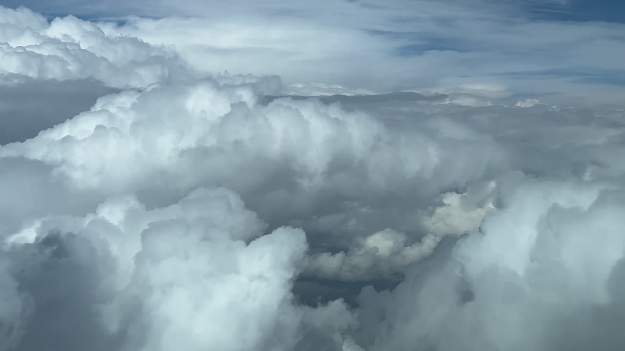 Immersive pilot’s FPV POV while flying across a stormy sky full of huge threatening stormy clouds. Daylight, blue sky. 4K