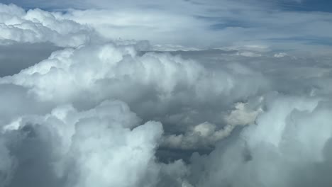 immersive pilot’s fpv pov while flying across a stormy sky full of huge threatening stormy clouds. daylight, blue sky. 4k