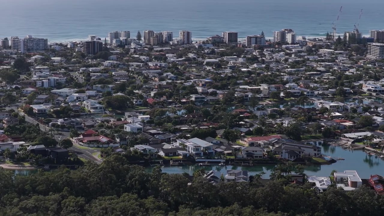 Cảnh quay chậm từ trên không lia sang trái qua Palm Beach, Tallebudgera Creek và các khu dân cư xung quanh trên Gold Coast, Queensland, Úc.