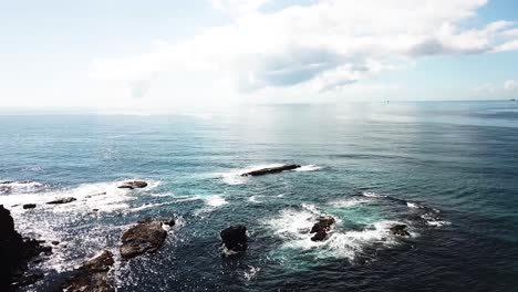 aerial top view of large waves. drone shot of rocky seashore. sea coastline with extreme waves hitting rocks. waves crashing rocky beach. sea waves splashing