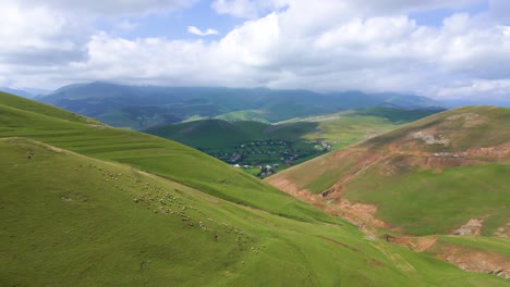 drone shot flying through the caucasus mountains in the gadabay district in azerbaijan towards a village