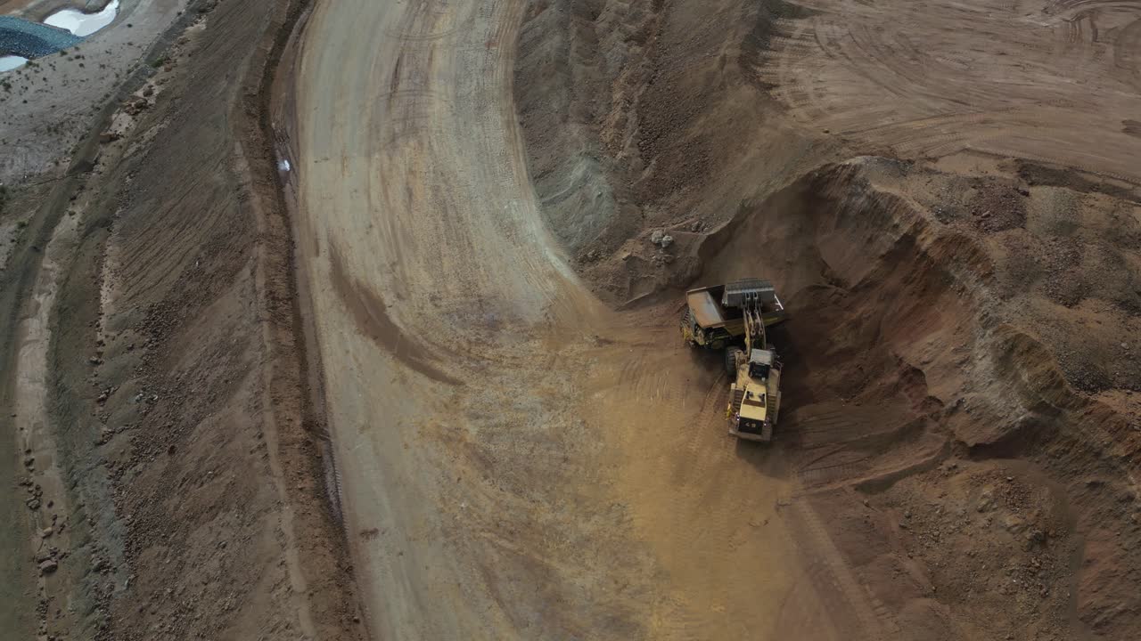 Orbit Shot Of Excavator Filling Up Truck In Nickel Mine Site In Western Australia