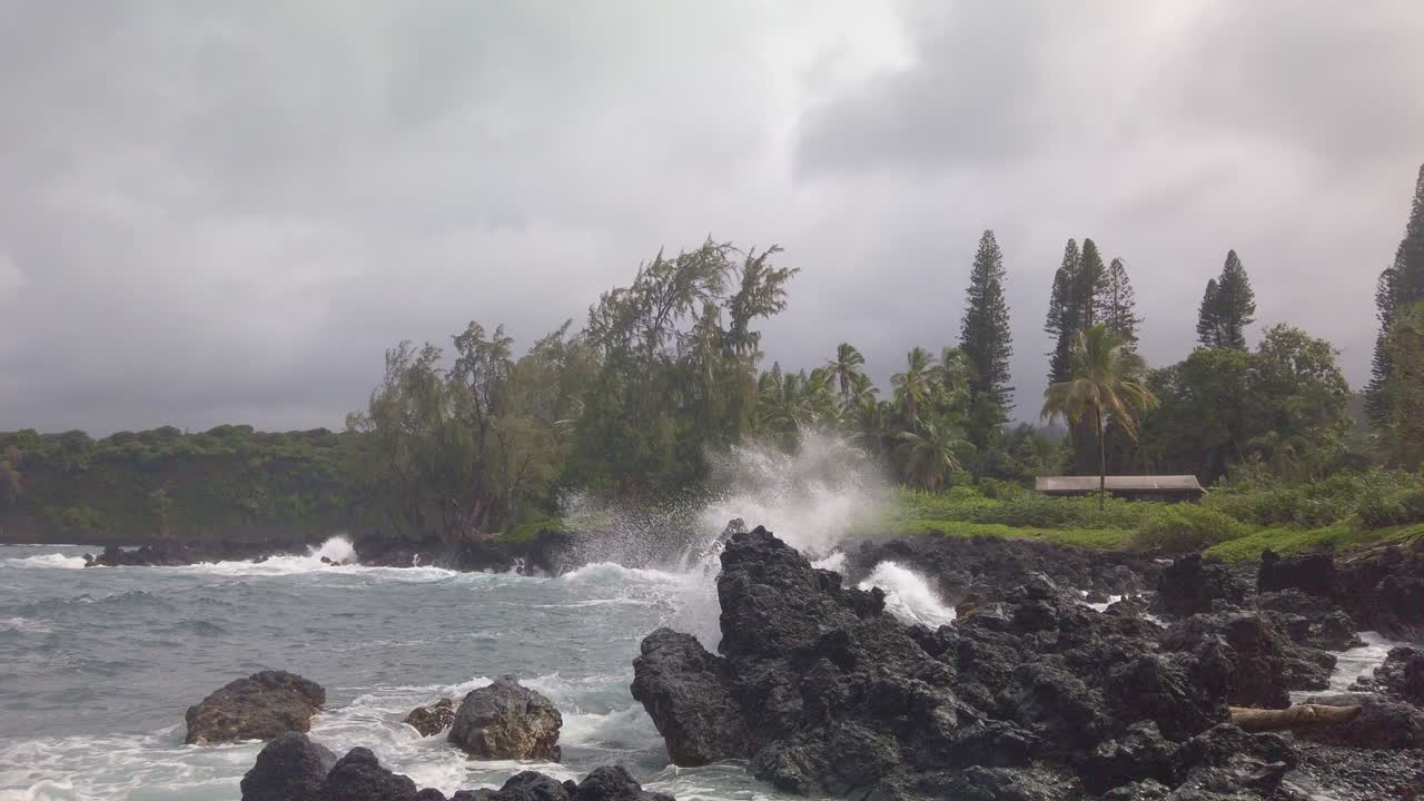 Gimbal close-up shot of strong waves hitting lava rock off the coast of Hana in Maui, Hawai'i