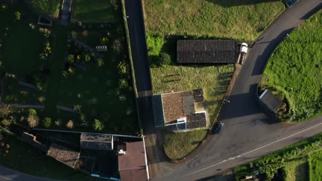 Top-down-view-of-small-european-farm-town-with-cars-on-roads-and-rooftops-on-the-Azores-Islands