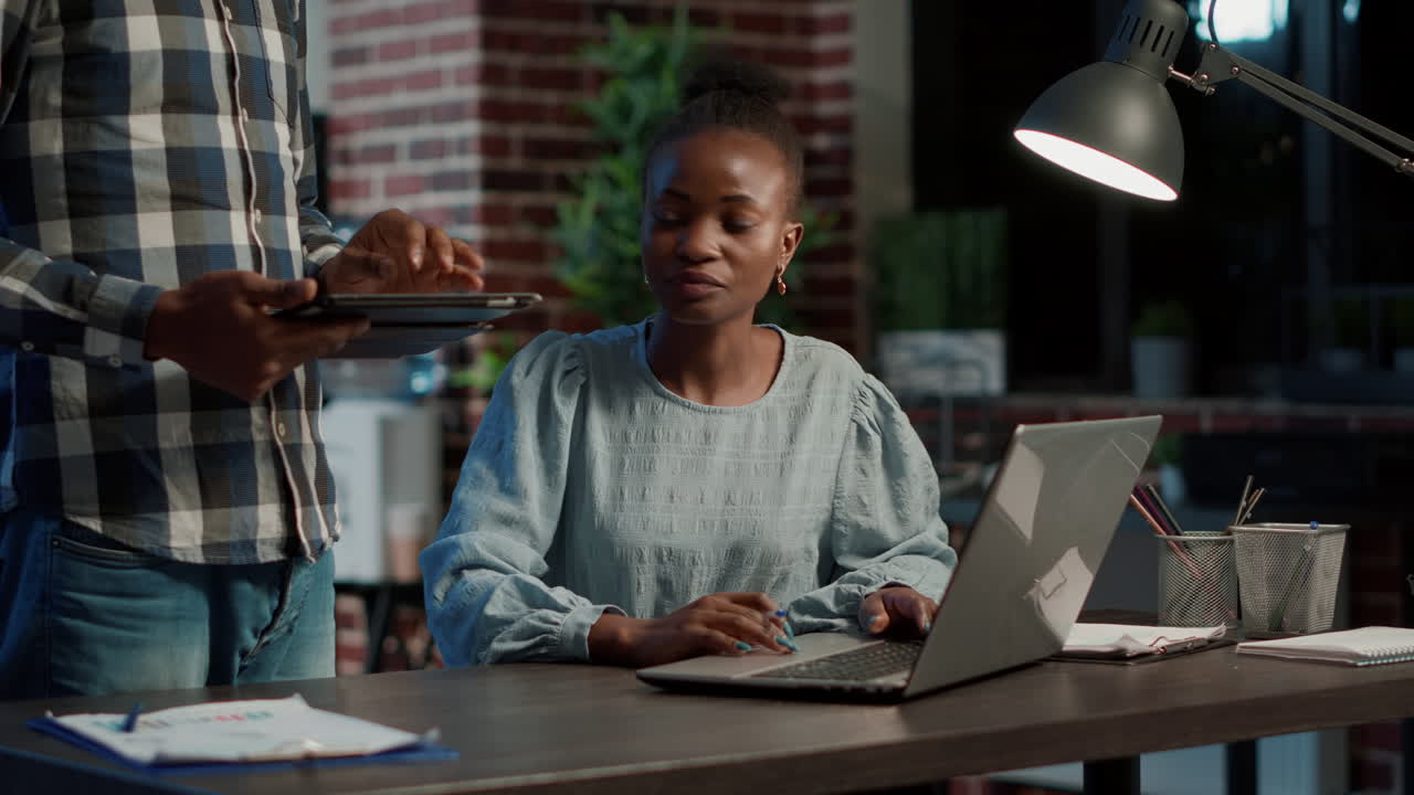 Business team using digital tablet and laptop to discuss trade strategy