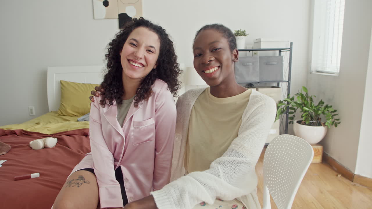 Portrait of Biracial Girlfriends in Pajamas Smiling at Camera