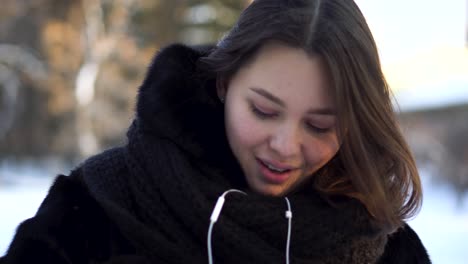 woman listening to music in winter park