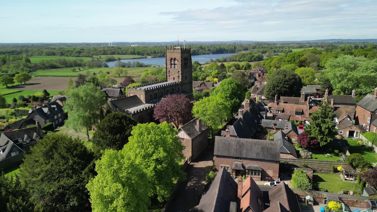 Beautiful St Mary and All Saints Church by drone in the picturesque village of Great Budworth - slow landing - Cheshire, UK