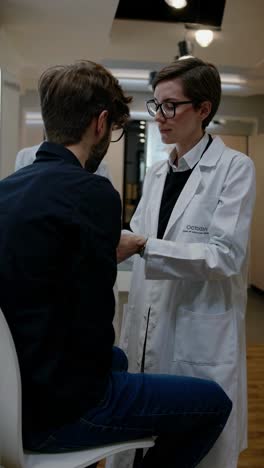 a doctor consults a patient in a modern clinic. the video captures a close-up, eye-level angle