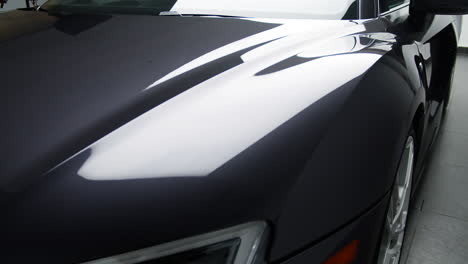 smooth and shiny hood of a brand-new sports car. - close up