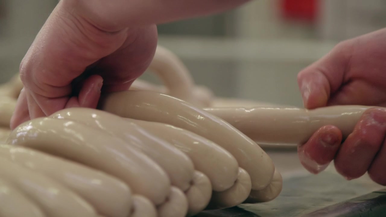Industrial production of sausages. Sausages being made at meat processing factory.