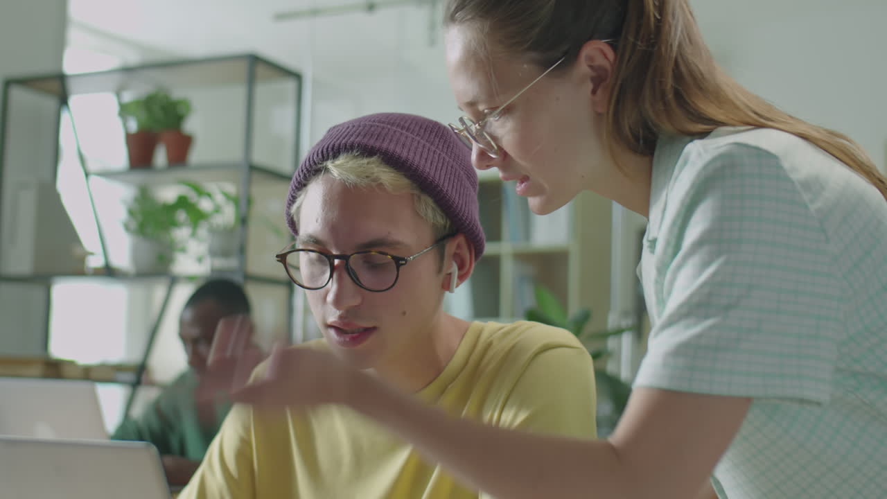 Gen Z Colleagues Having Discussion about Work in Office