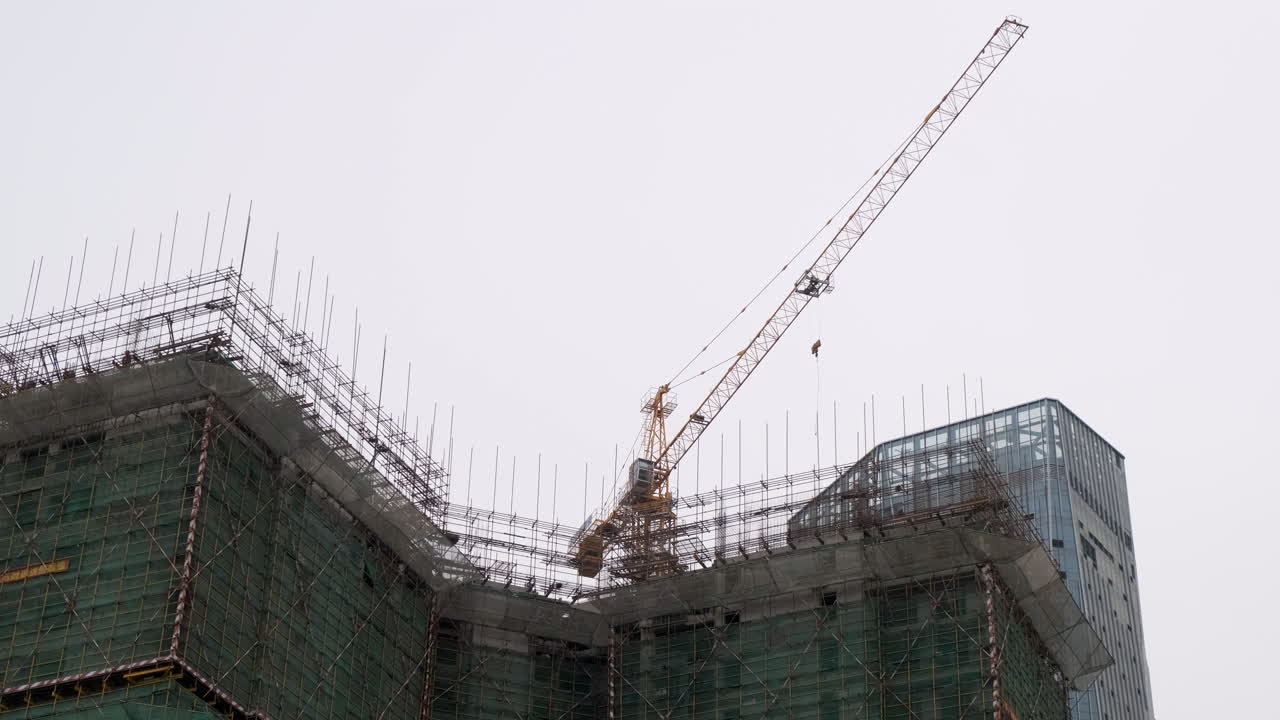 Large Tower Crane Moving at a Building Construction Site
