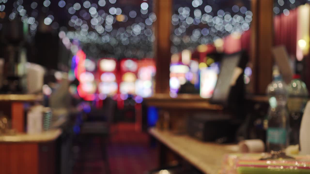 Interior of Casino, bar and slot machines in background, blurry view, static shot
