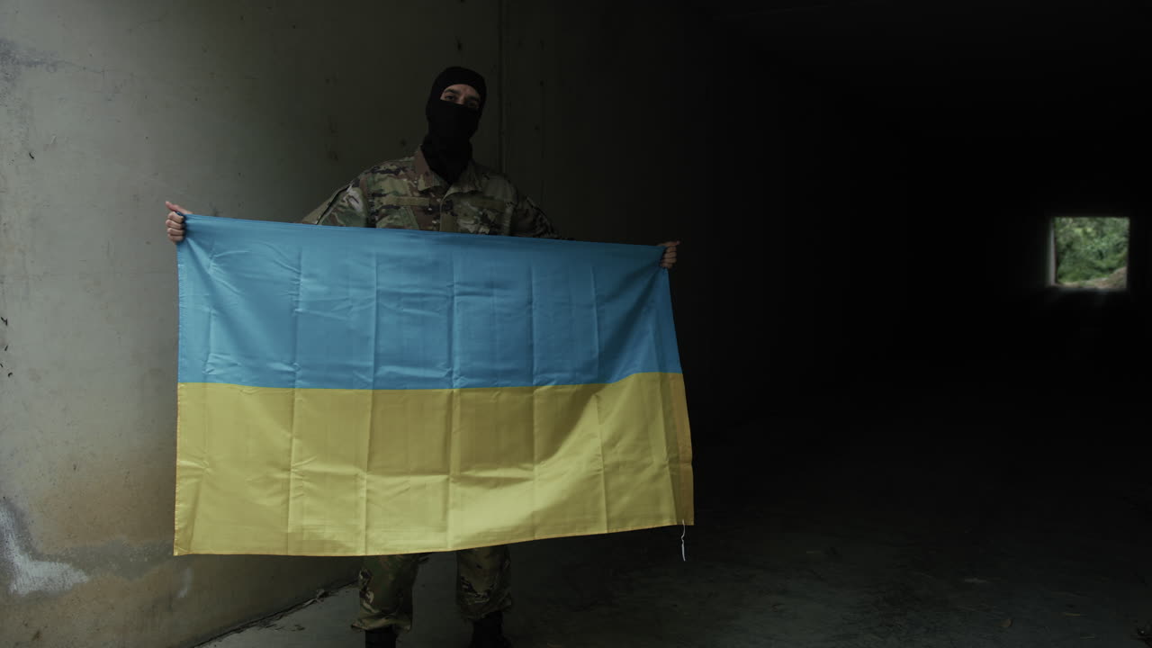 Ukrainian Soldier With National Flag Inside a Bunker