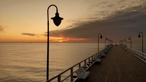 flight over pier near the lighthouse above the wooden railings