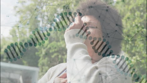 holding chest with dna strand and network overlay, person outdoors with animation