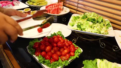 serving tomatoes at a breakfast buffet