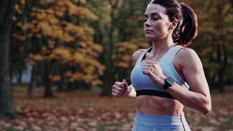 a focused woman jogs through a sunlit autumn forest, capturing the essence of determination