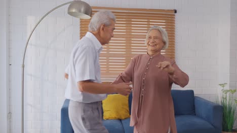 elderly couple dancing at home