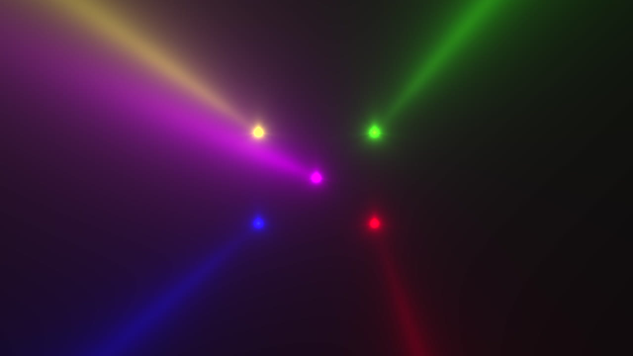 Colorful glowing spotlight beams on black gradient stage