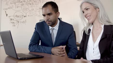 business man and woman using computer for video call