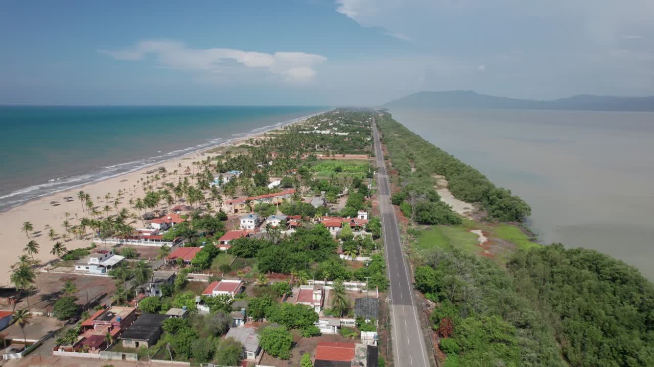 Backwards aerial of sand strip dividing Caribbean Sea and Unare Lagoon