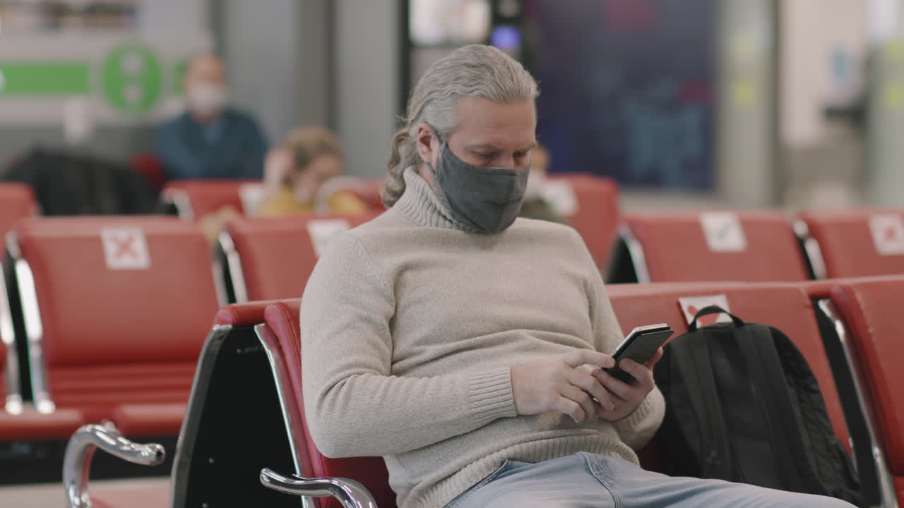 Man Waiting In Departure Lounge