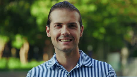 portrait of a happy young man smiling outdoors