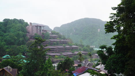 rainy season in south east asia, downpour over koh phi phi resort in lush jungle