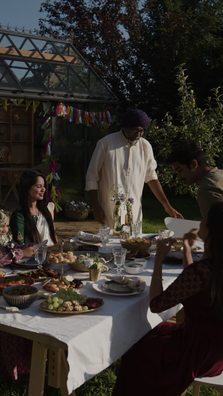 A festive outdoor meal with family and friends in a garden setting