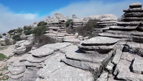 Flying-with-a-drone-through-the-natural-area-of-​​El-Torcal,-a-karst-area-located-in-Antequera-in-the-province-of-Malaga,-Spain