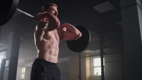 slow motion: male powerlifter preparing for training in gym. screaming man lifting weights