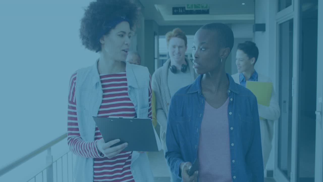 Leader gesturing tablet and initiating dynamic chart, team walking corridor showing business update