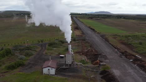 small geothermal electricity power plant in rural iceland with car driving by