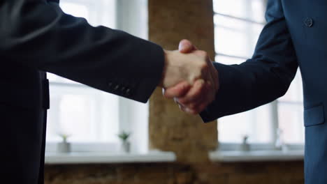 business men shaking hands after successful signing contract in office close up.